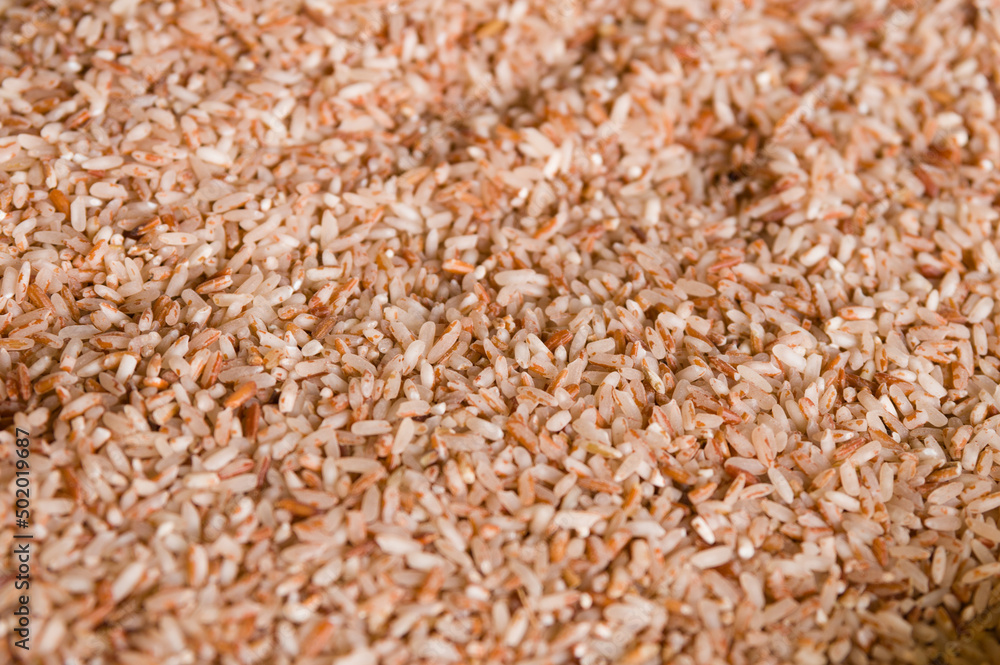 Closeup of healthy peeled heap of red rice Closeup of healthy peeled heap of red rice