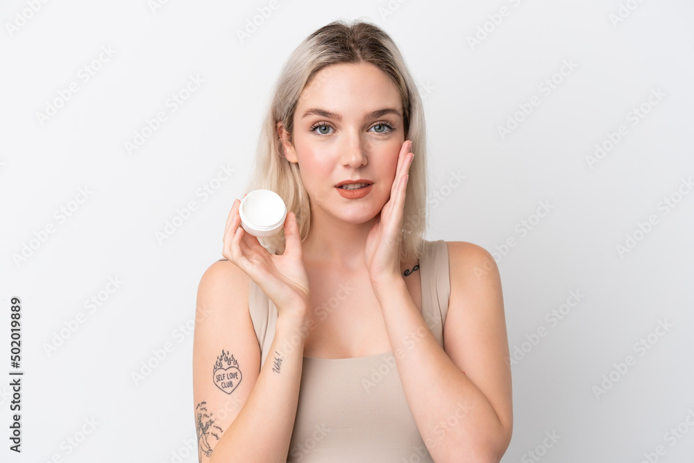 Young caucasian woman isolated on white background with moisturizer Young caucasian woman isolated on white background with moisturizer