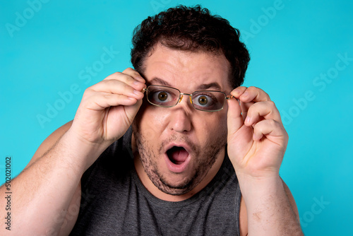 Surprise and shock. Funny fat man with glasses. 