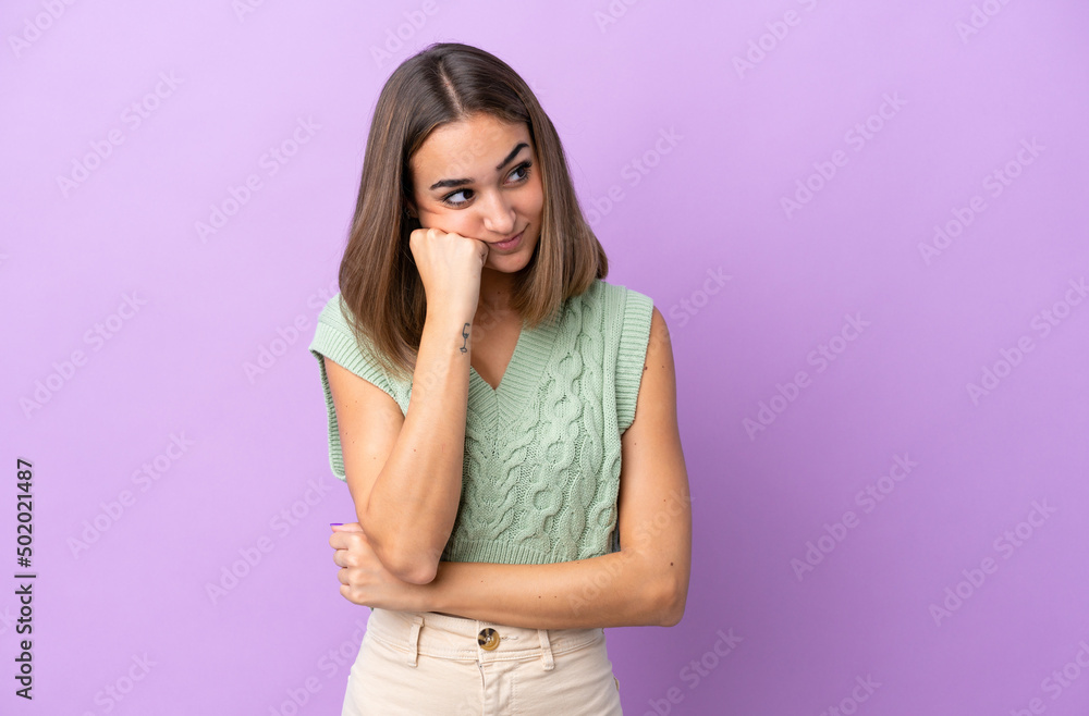 Young caucasian woman isolated on purple background with tired and bored expression Young caucasian woman isolated on purple background with tired and bored expression