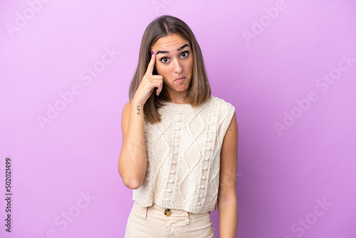 Young caucasian woman isolated on purple background thinking an idea