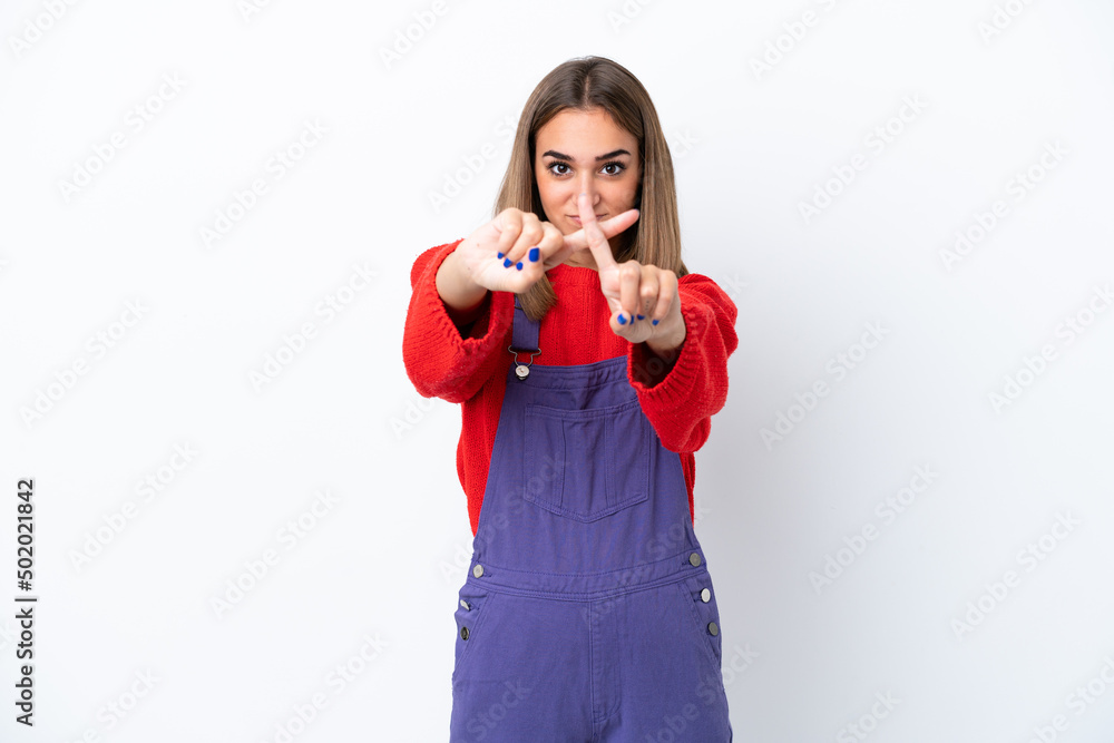 Young caucasian woman isolated on white background making stop gesture with her hand to stop an act Young caucasian woman isolated on white background making stop gesture with her hand to stop an act
