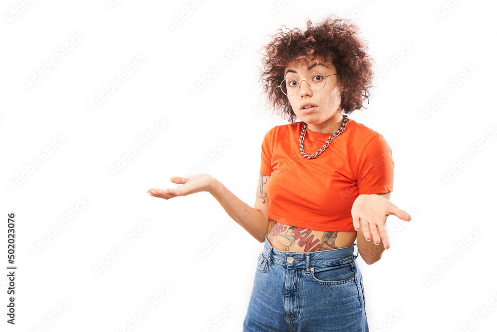 Funny curly girl shrugging hands thinks doubts, makes decision isolated on white studio background Funny curly girl shrugging hands thinks doubts, makes decision isolated on white studio background