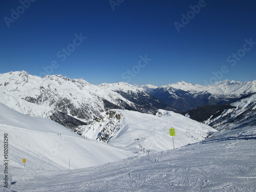 Beautiful view of alps in Les Sybelles, France. Snow capped mountains against the sky. Sunny day in Saint Sorlin d'Arves. France. Fun during holidays. Ski business. Winter landscape.. photo