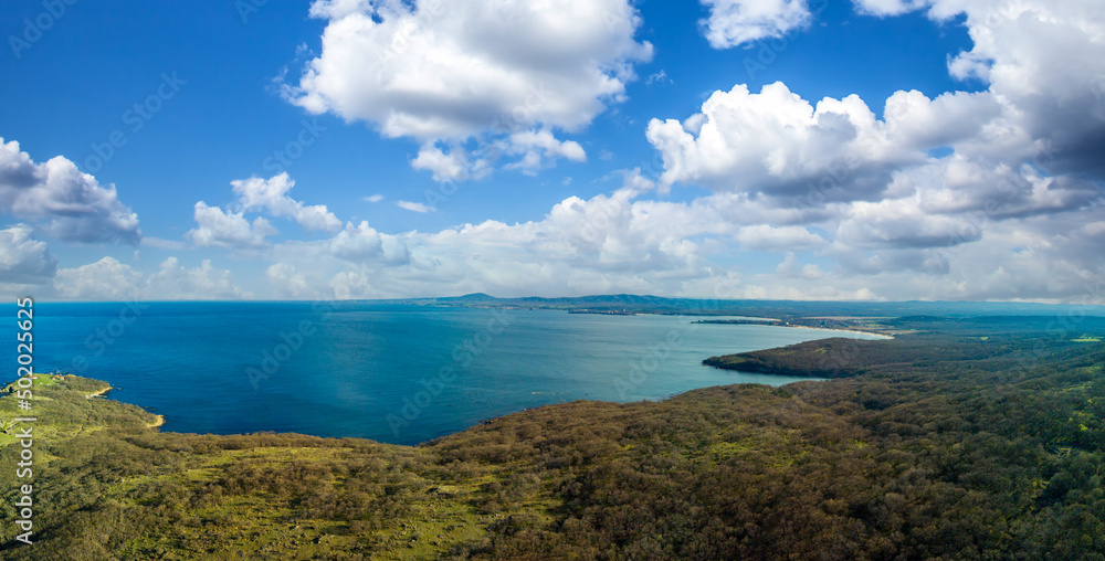 Fototapeta premium Panorama view from a height of a beach with a forest near the Black Sea in the country of Bulgaria