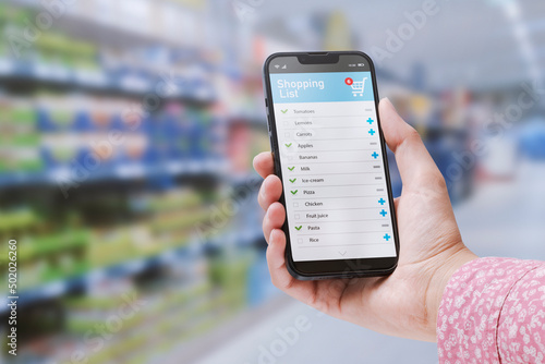 Woman checking her grocery list on the phone