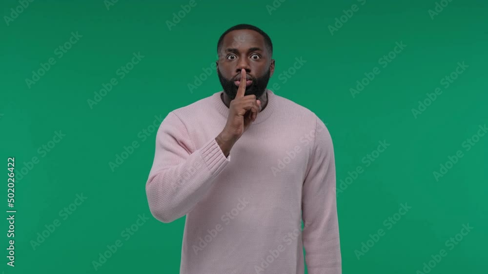 African American man showing hush gesture isolated on Green Screen, Chroma Key background, keeping finger on lips, privacy African American man showing hush gesture isolated on Green Screen, Chroma Key background, keeping finger on lips, privacy