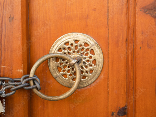 Chain and lock on historic wooden door