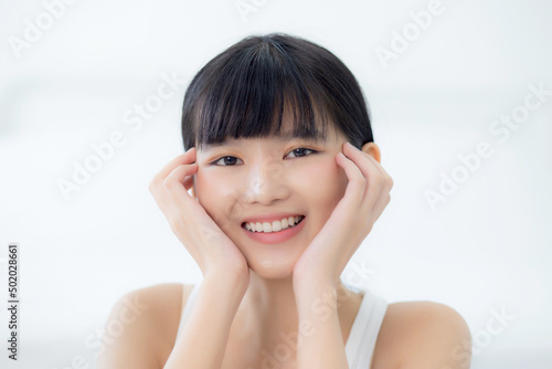 Beautiful young asian woman makeup of cosmetic, girl hand touch cheek on face and smiling attractive, facial of beauty perfect skincare with wellness and wrinkle, skin care and health concept.