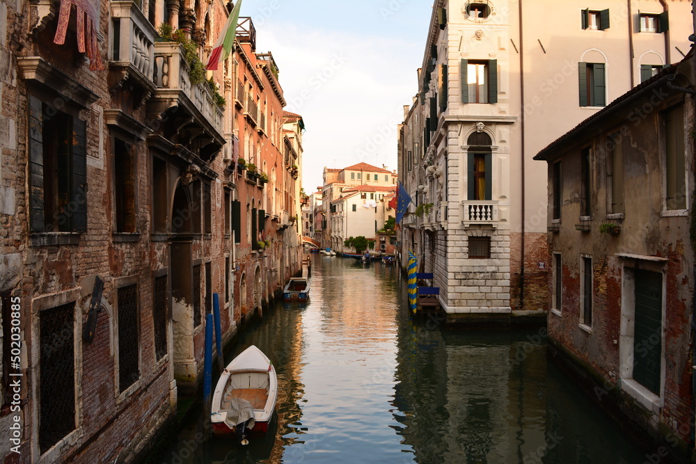 canal in venice with small boat