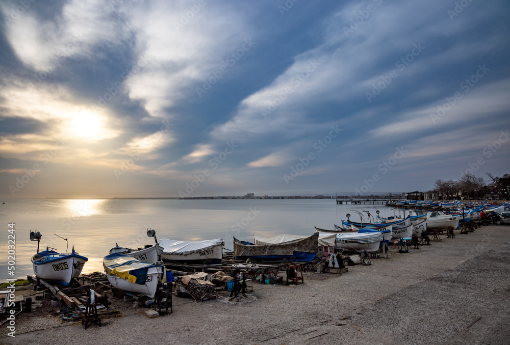 A lot of boats and boats on the pier near the Black Sea against the backdrop of sunset A lot of boats and boats on the pier near the Black Sea against the backdrop of sunset