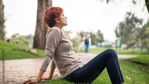 latin woman breathing air taking a moment from work in the park bogota colombia