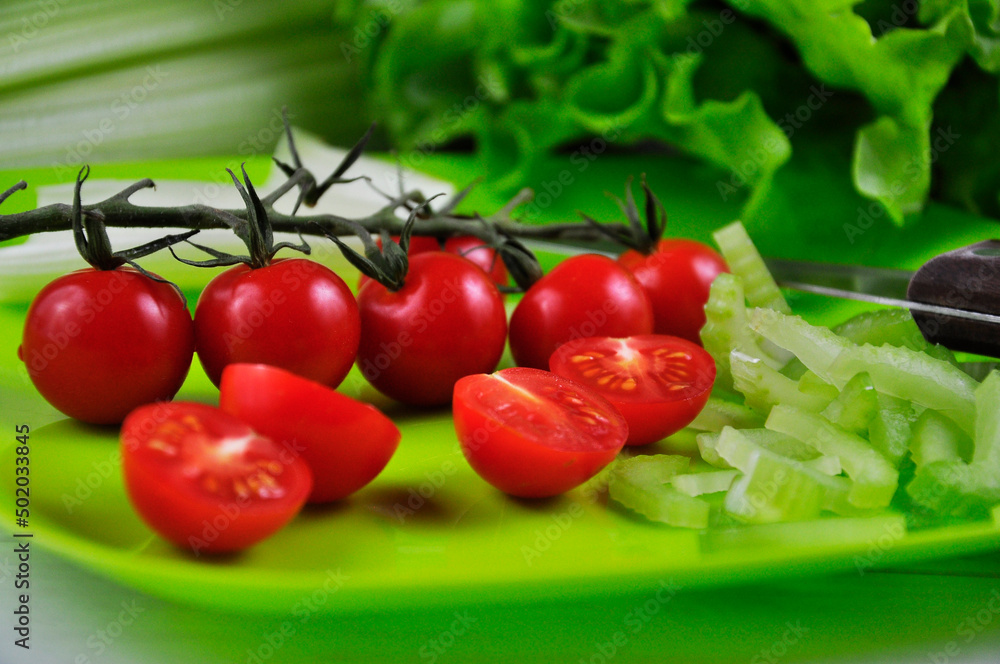 Sliced celery stalks and cherry tomatoes Sliced celery stalks and cherry tomatoes