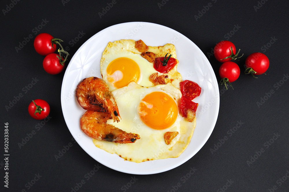 Fried eggs with shrimp in a frying pan. Fried eggs with shrimp in a frying pan.