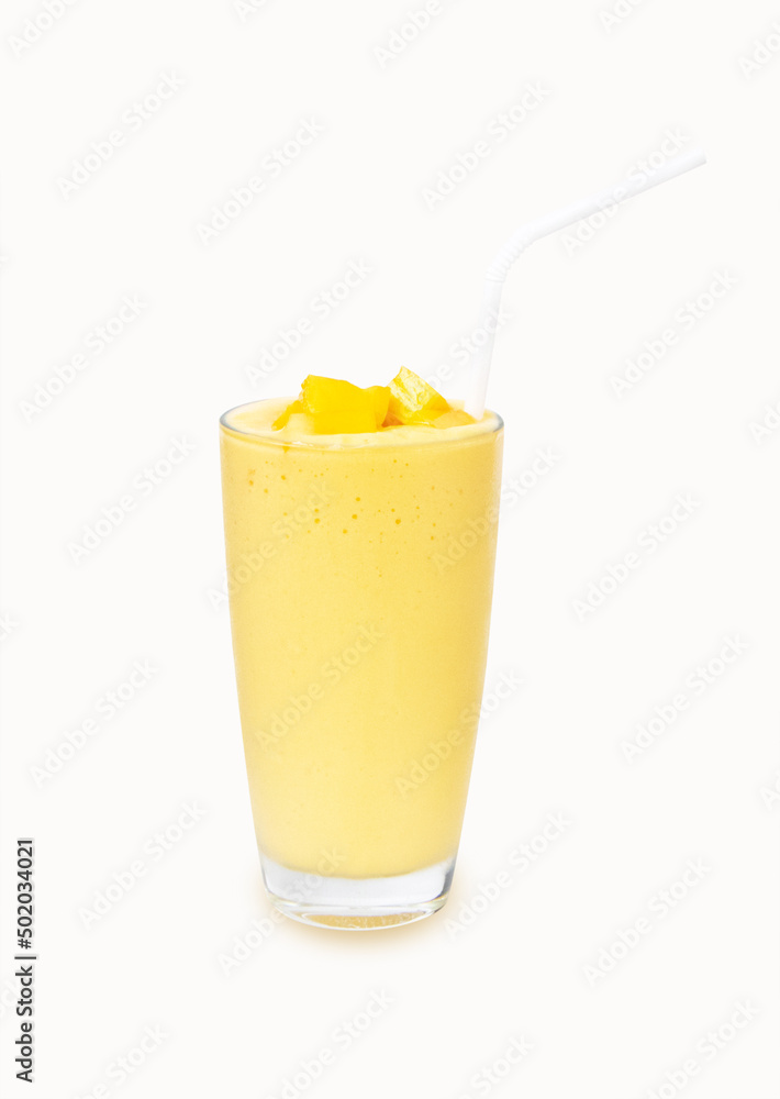 Fresh Mango ripe organic yellow smoothie honey mix in glass with straw. Isolated on white background.There is vitamin C. Perfect for summer drink. Garnish. Ripe mangoes are popular all over world. Fresh Mango ripe organic yellow smoothie honey mix in glass with straw. Isolated on white background.There is vitamin C. Perfect for summer drink. Garnish. Ripe mangoes are popular all over world.