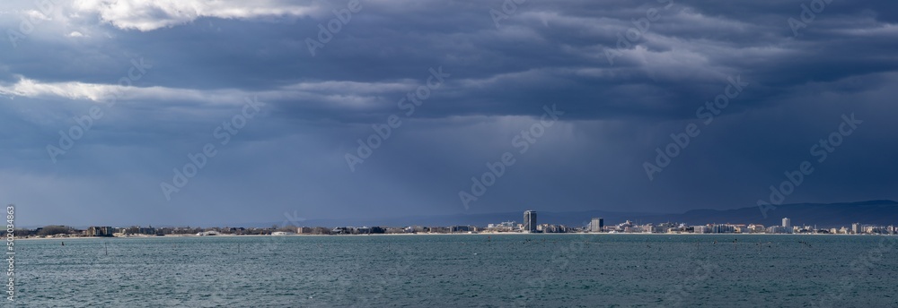 Panorama of the evening city located on a peninsula near the Black Sea covered with clouds