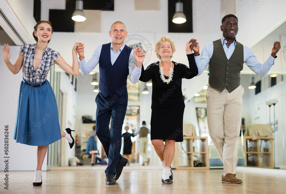 Group of different age dancers preparing swing performance