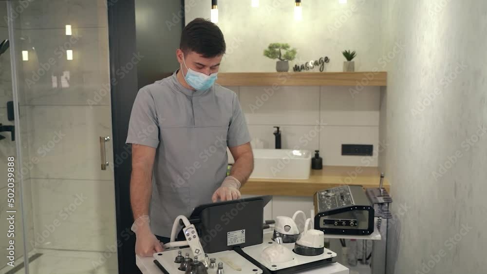The doctor prepares the equipment for work The doctor prepares the equipment for work