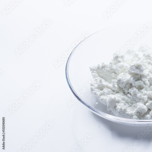cottage cheese in a glass transparent bowl isolated on a white background