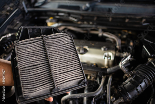 Car air filter that is used and full of dust, air filter may result in engine problems. © Sky Stock