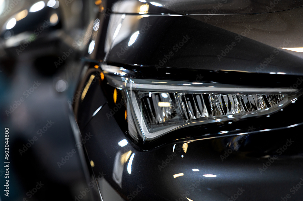 Luxury car tail light on a dark brurred background. Luxury car tail light on a dark brurred background.