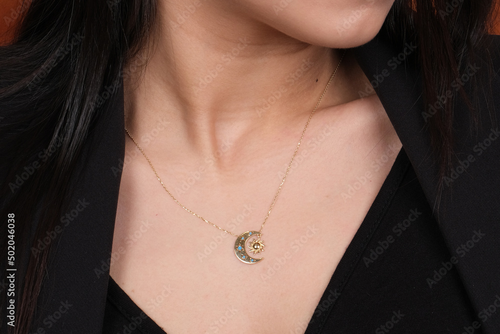 Close-up young woman wearing gold chain necklace. Modern fashion details. minimalist lifestyle