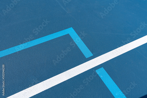 Blue tennis court with white lines combined with light blue pickleball lines © Thomas
