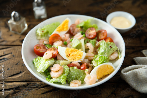 Homemade salad with shrimps and eggs