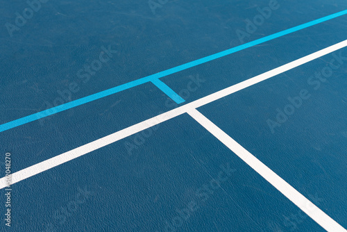 new blue outdoor tennis courts with white lines and combined light blue pickleball lines