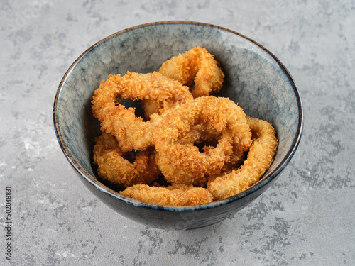 Squid rings in batter on a light background