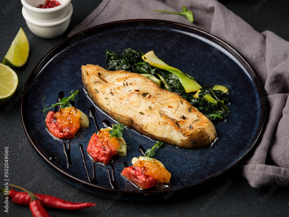Halibut steak with garnish. Halibut steak with garnish.