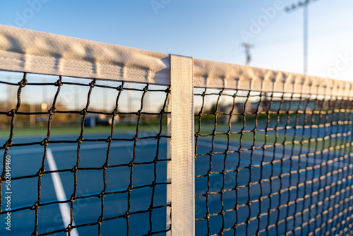 Close up of top of tennis court net, late afternoon. © Thomas