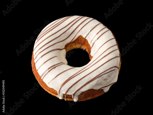 Biscuit donut with white icing on a black background