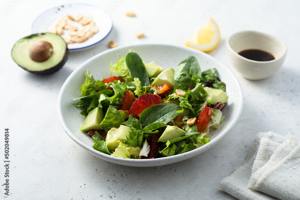 Healthy green salad with avocado and bloody orange Healthy green salad with avocado and bloody orange