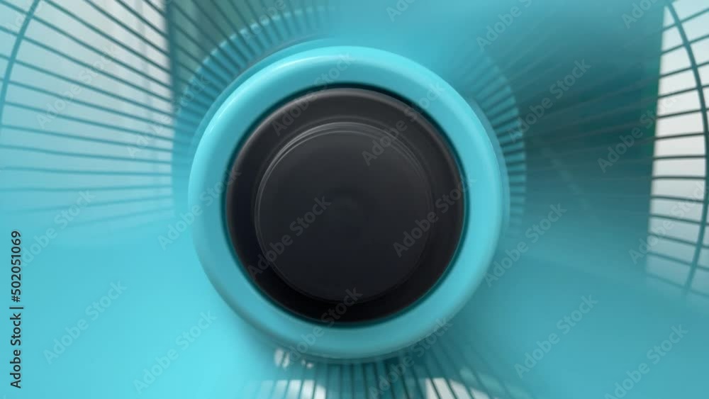 Fan blade spinning blow wind cooling electric fan. Turn on the fan speed then blade slowly stop close up shot daytime. DIY household self assembly concept Fan blade spinning blow wind cooling electric fan. Turn on the fan speed then blade slowly stop close up shot daytime. DIY household self assembly concept