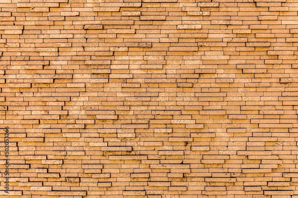 Yellow brick wall. Background of rectangular gray tiles of different sizes. Yellow brick wall. Background of rectangular gray tiles of different sizes.
