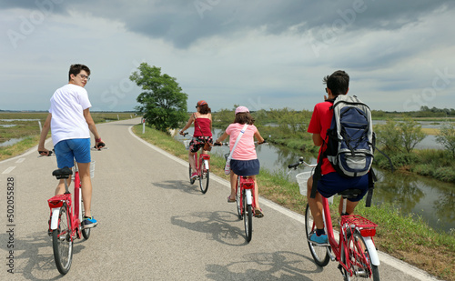 family of four during the bike ride on the bike path and the lagoon photo