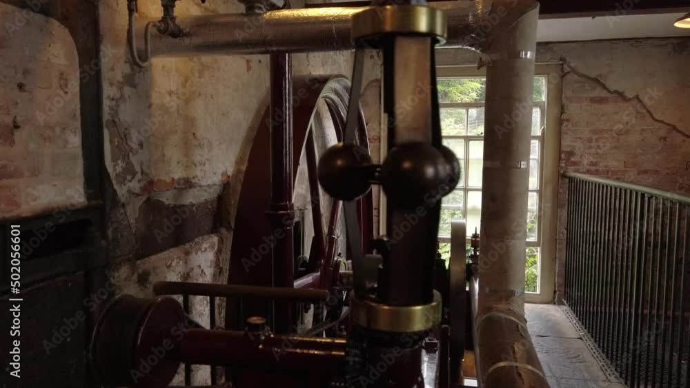A horizontal steam engine at a working cotton mill. Regulator valve spinning. A horizontal steam engine at a working cotton mill. Regulator valve spinning.