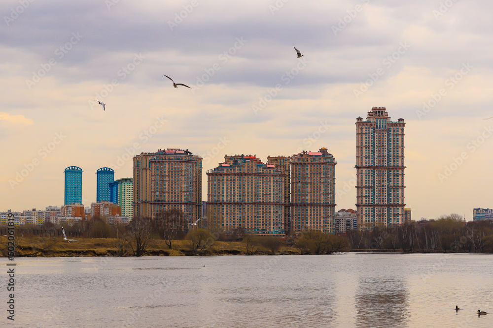 Cityscape with a new residential complex on the banks of the river.