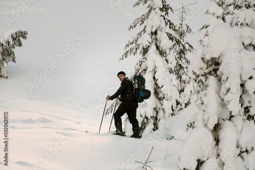 Photos view of skier climbing the hill on splitboard