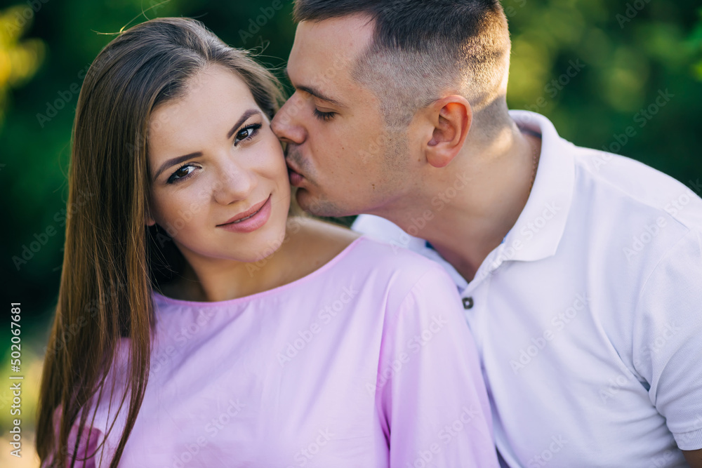 romantic date. A man kisses a girl, enjoys a date in the park, close-up romantic date. A man kisses a girl, enjoys a date in the park, close-up