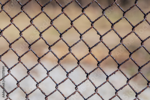 Metal mesh with traces of corrosion close-up on a natural background. Abstract background with repeating elements. 