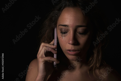 Obraz na płótnie Female victim of domestic abuse phoning support group. Calling for help. w salonie
