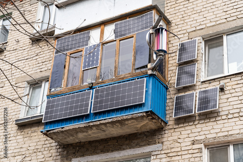 Green energy from solar panels on the balcony in a high-rise building gives free electricity to a separate apartment and save money