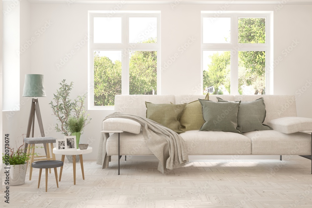Fototapeta premium White living room with sofa and summer landscape in window. Scandinavian interior design. 3D illustration