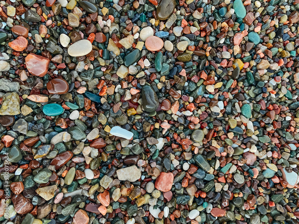 Set of beautiful colorful stones with different pattern polished by the sea. Textured background of minerals and crystals on the beach. Abstract nature background with colorful pebble stones. Set of beautiful colorful stones with different pattern polished by the sea. Textured background of minerals and crystals on the beach. Abstract nature background with colorful pebble stones.