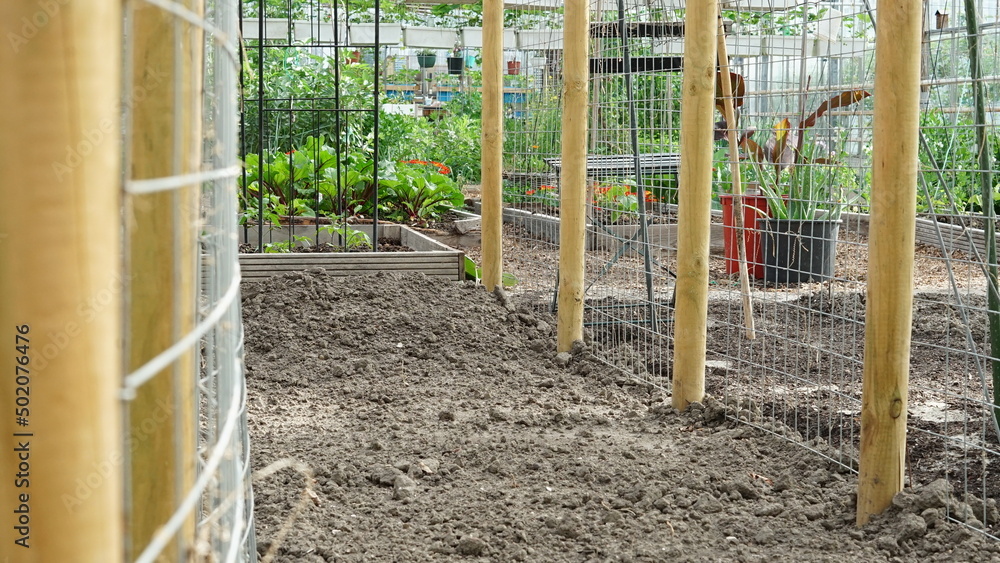 Empty garden bed ready for planting with poles either sides horizontal Empty garden bed ready for planting with poles either sides horizontal