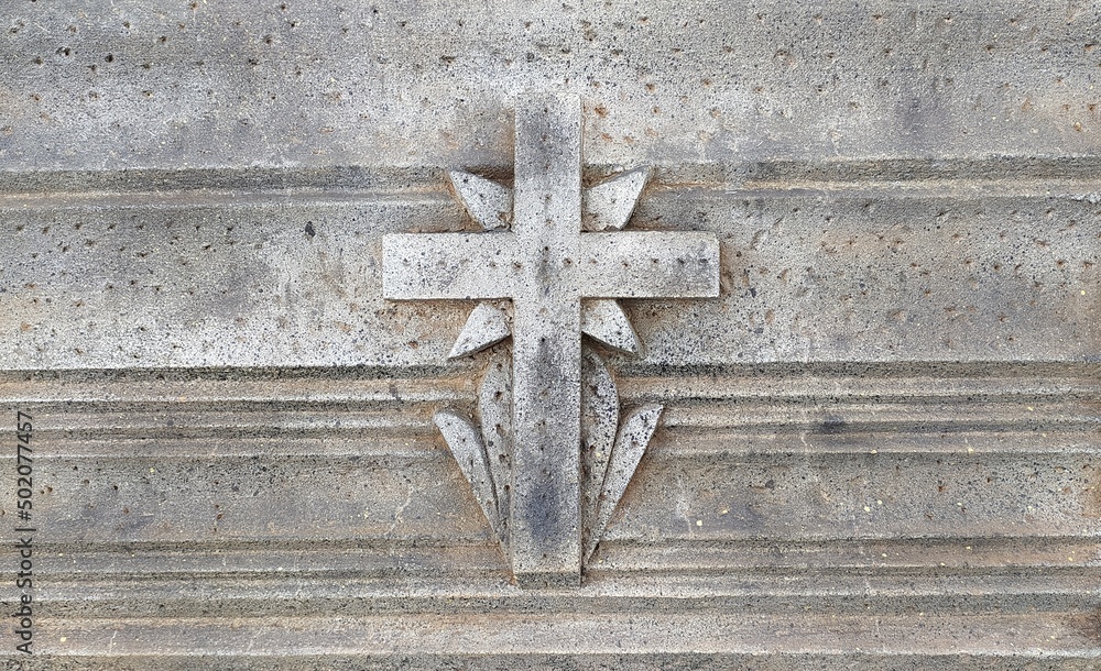 Holy Christian religion sign old anciant and vintage gray stone cross symbol made using concrete cement with copy space. which is used on the graveyard and cemetery. Beautiful closeup macro side view.