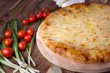 Ossetian pie with cheese and herbs on the table