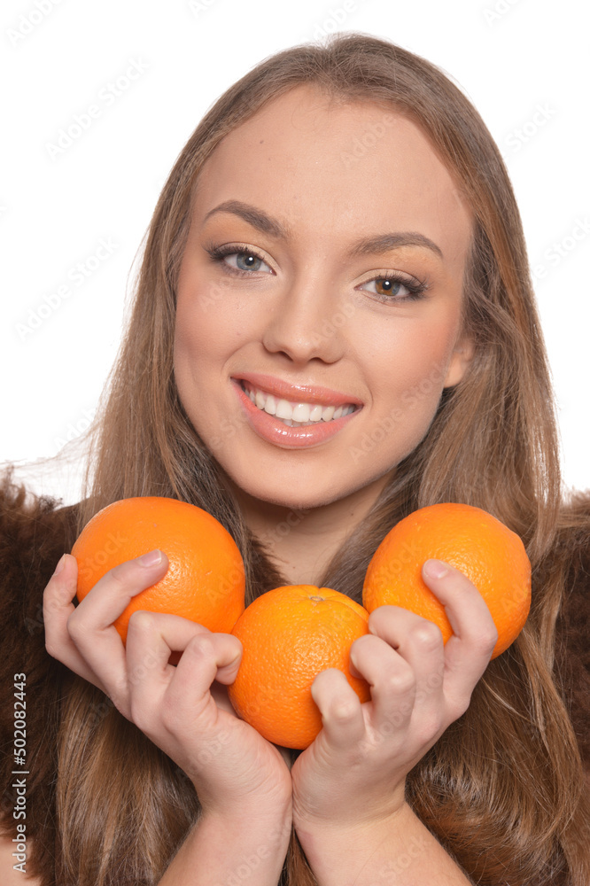 Portrait of young woman posing with oranges on white background Portrait of young woman posing with oranges on white background